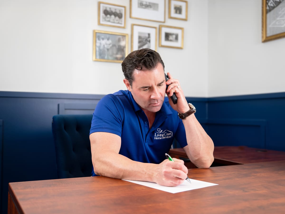 Dan Townsley, owner of Living Care, taking a client call at his desk