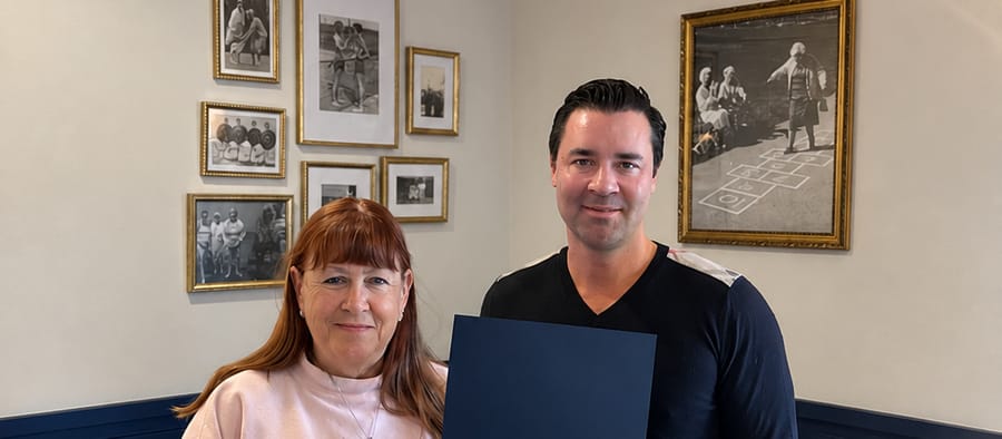 Dan Townsley presenting caregiver JoAnn Fretz with a Best of Friends home-care award at the Living Care office