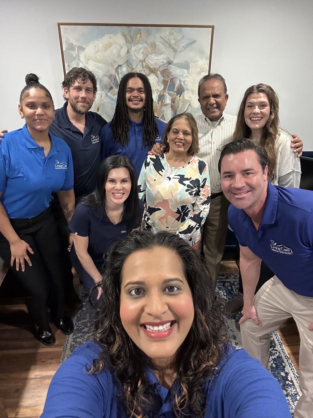The Living Care office team crowded into a smiling group selfie
